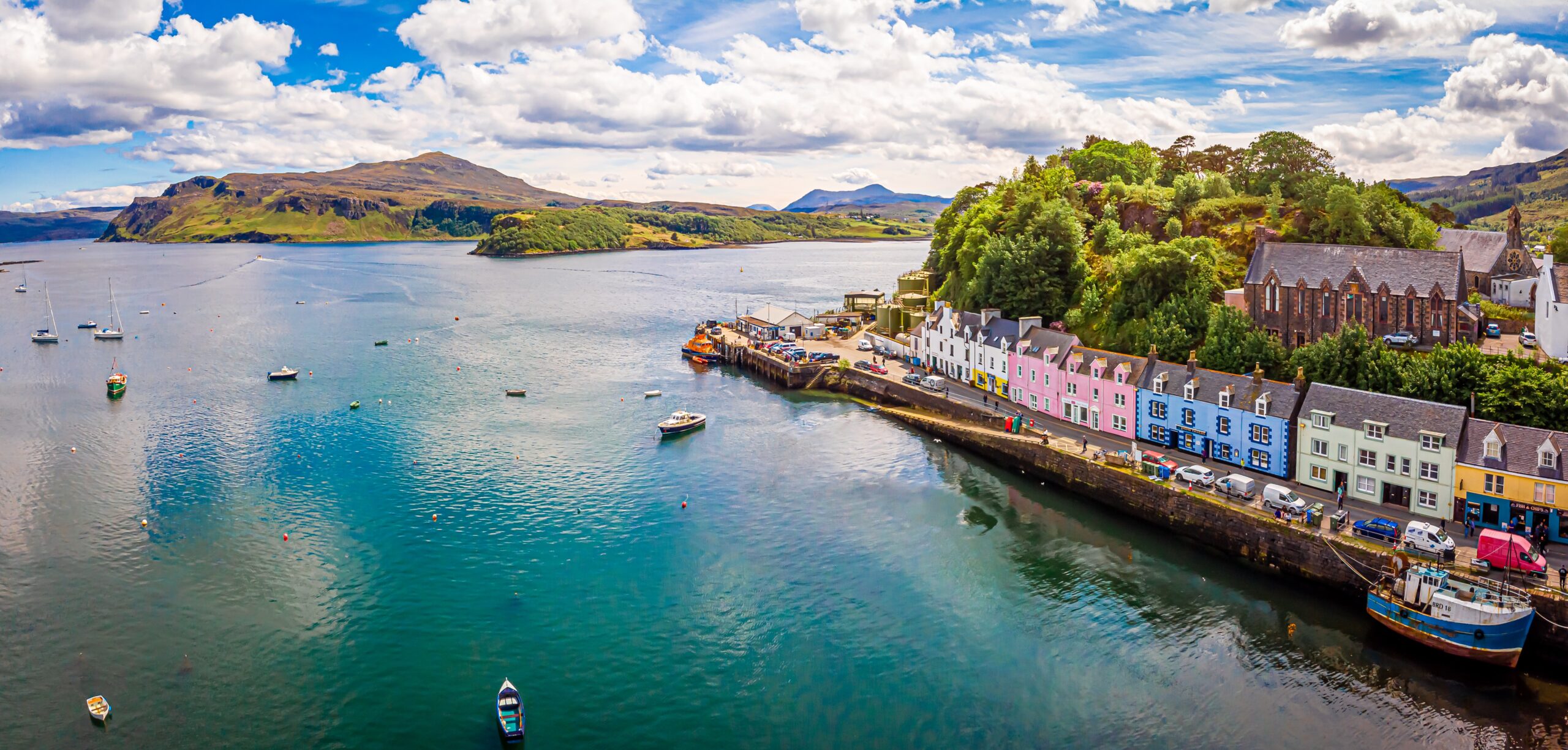 Colourful harbour town of Portree on the Isle of Skye with boats and coastal views, Scotland
