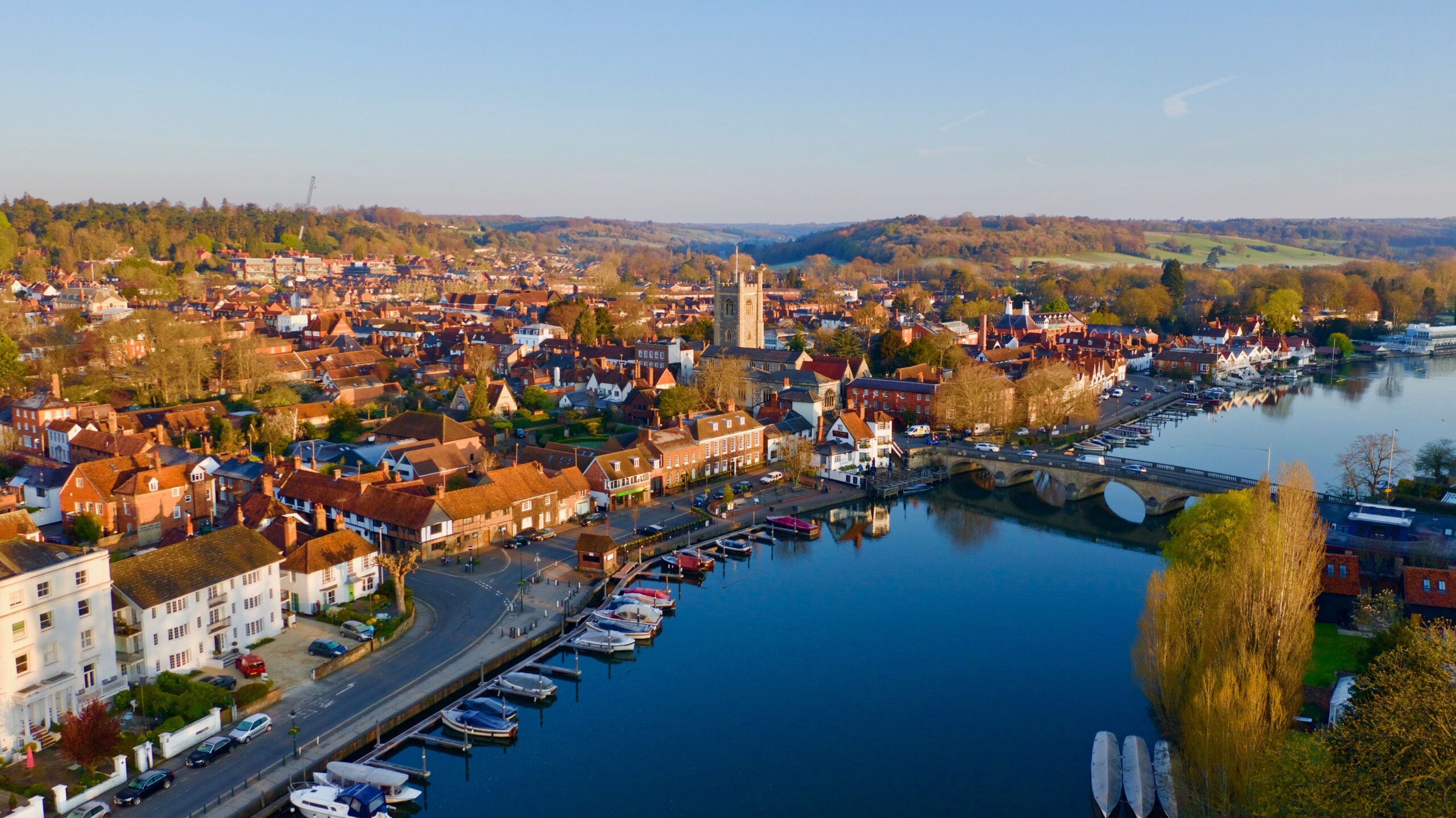 Aerial view of Henley-on-Thames showing the River Thames, historic bridge, boats, and town centre